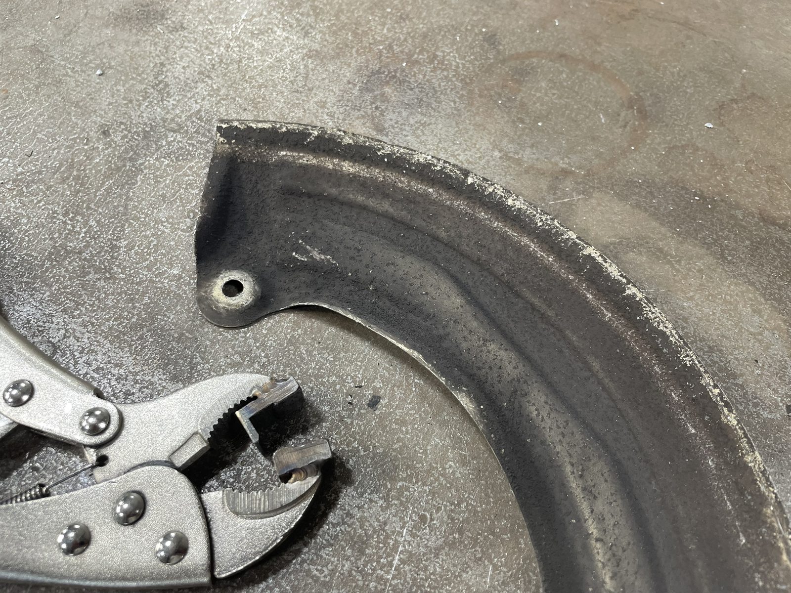 Reshaping the edge of the Porsche 964 brake dust shield to clear the larger Brembo rotor