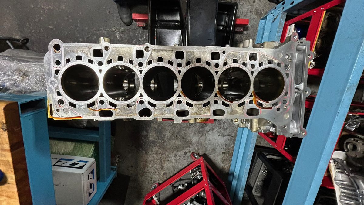 Bare S58 block showing all six cylinder bores and the deck surface before assembly