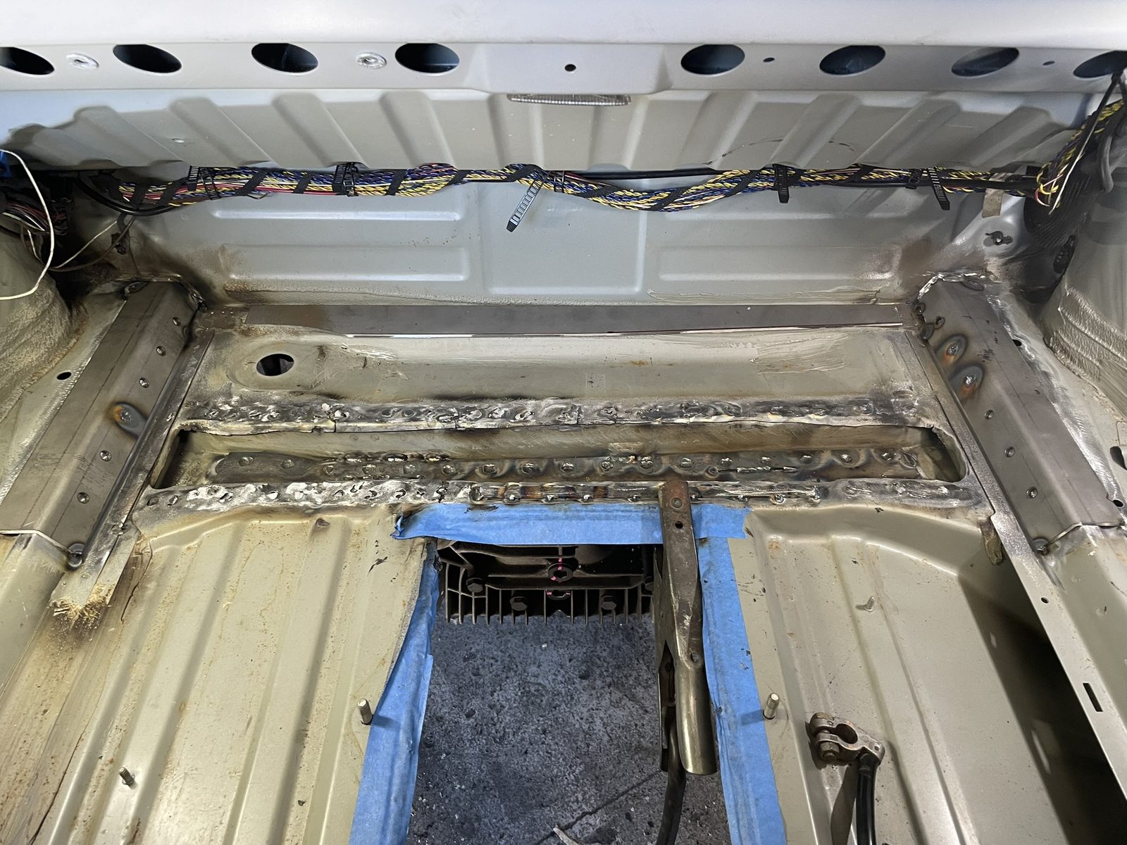 BMW Z3 rear floor with interior removed, exposing the subframe mounting rails
